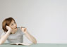  A women sitting with pen and paper 
