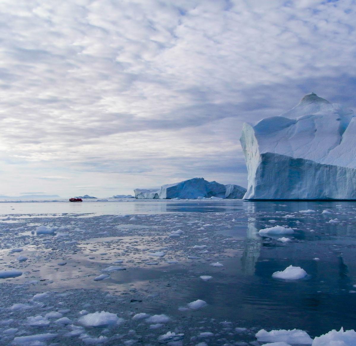 Bilde av hav med flytende isflak og isfjell.