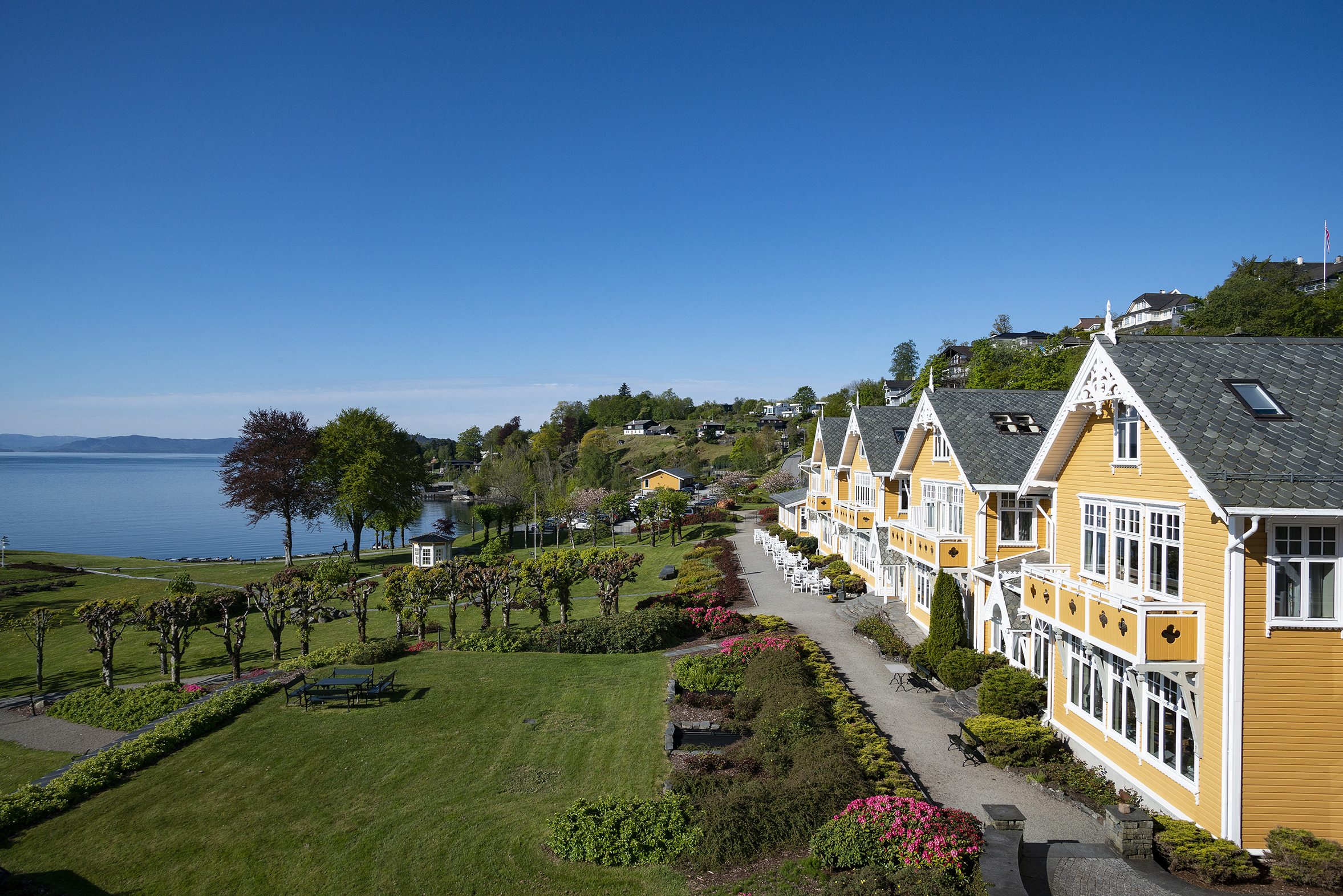 Historic building with garden and fjord