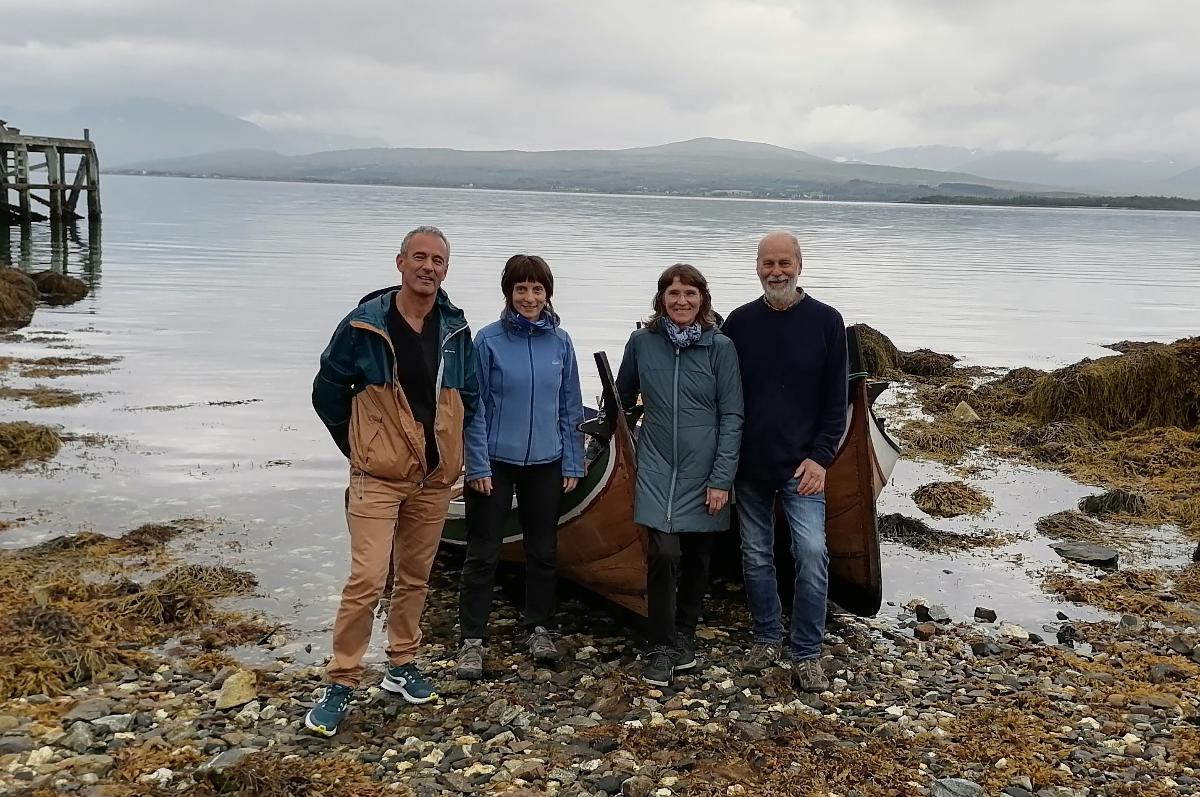 Four resarchers in front of traditional rowing/sailing boat, UiT, Tromsø.