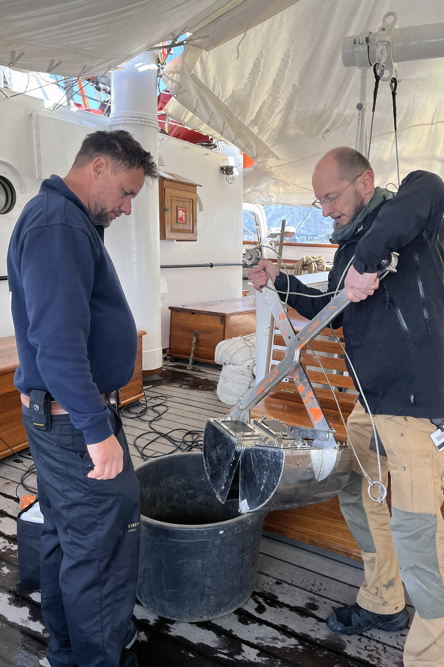 Two people inspecting a grab