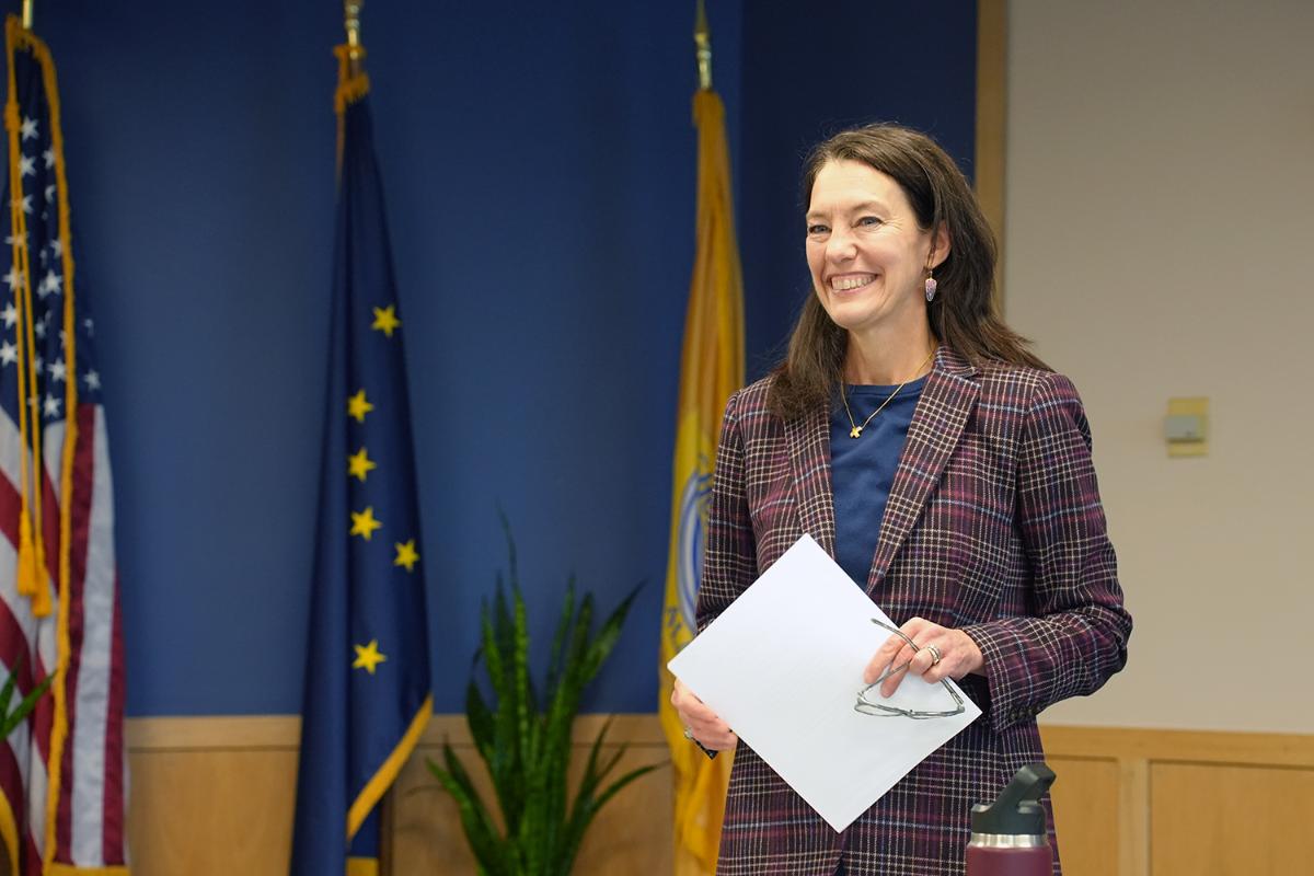 Kvinne står foran flagg