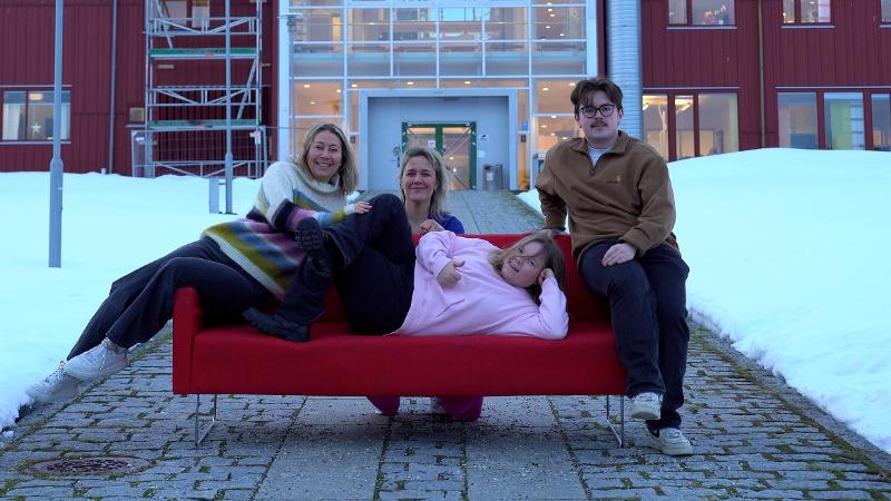 a group with a red sofa outdoors
