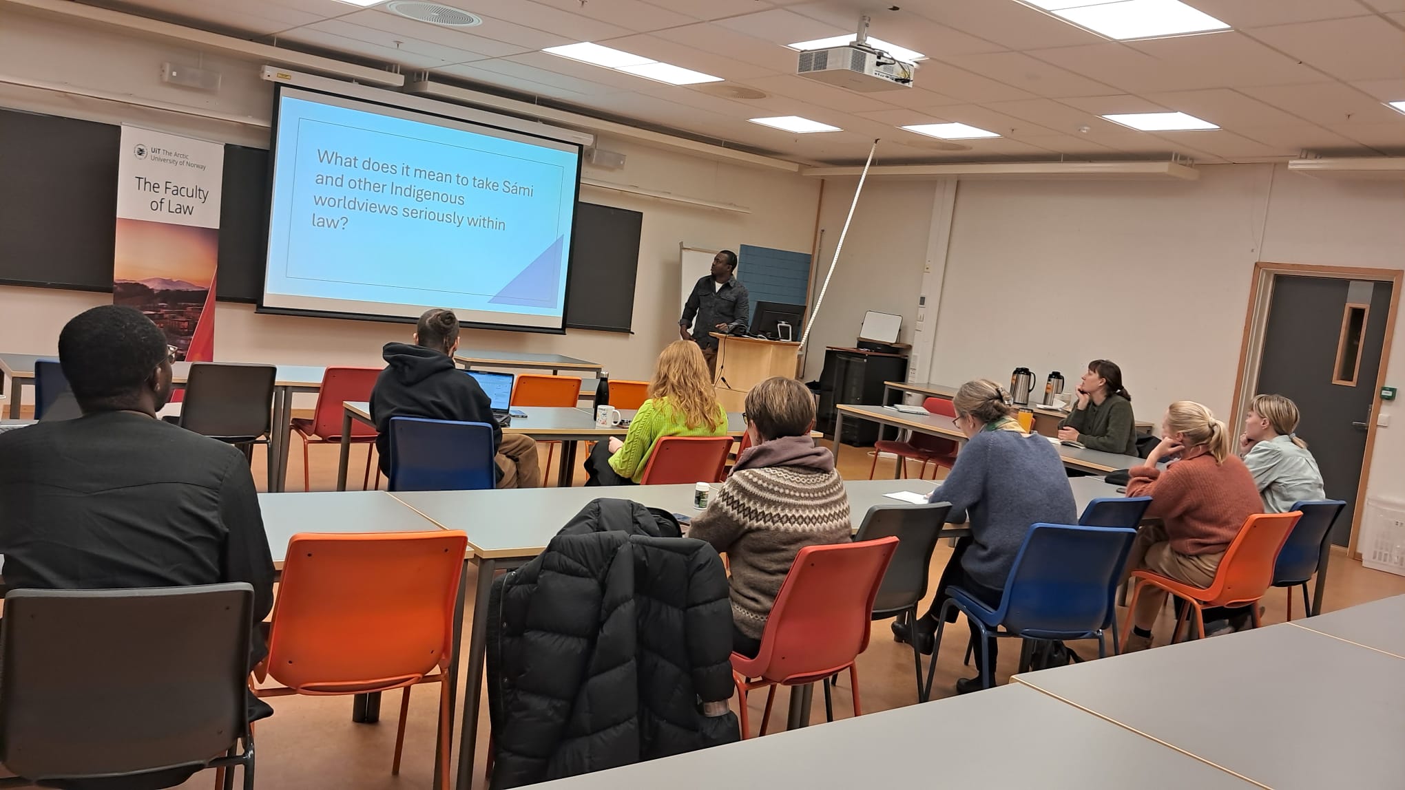 man standing next to a powerpoint.