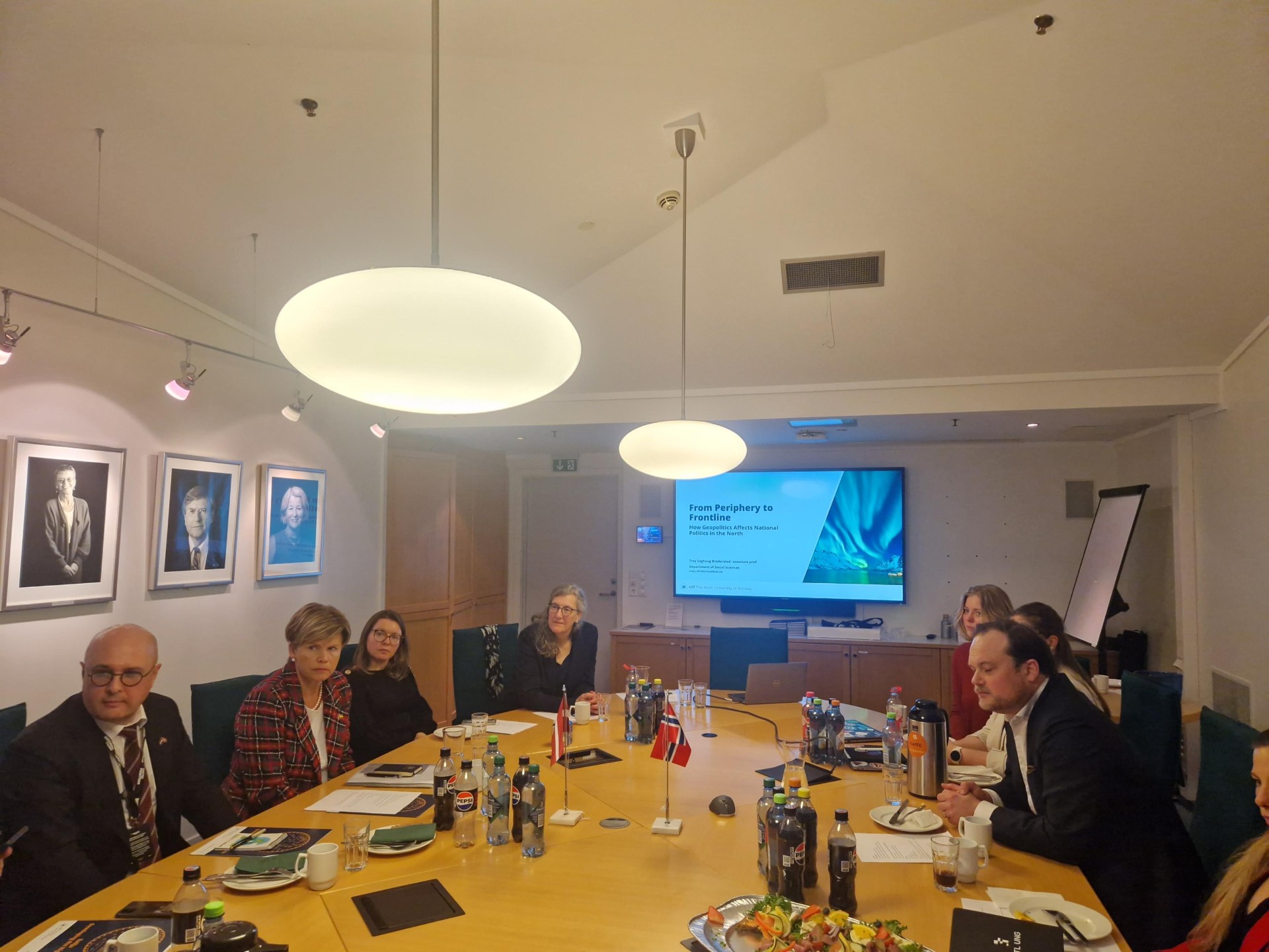 multiple people, sitting i circle, around a table, discussing