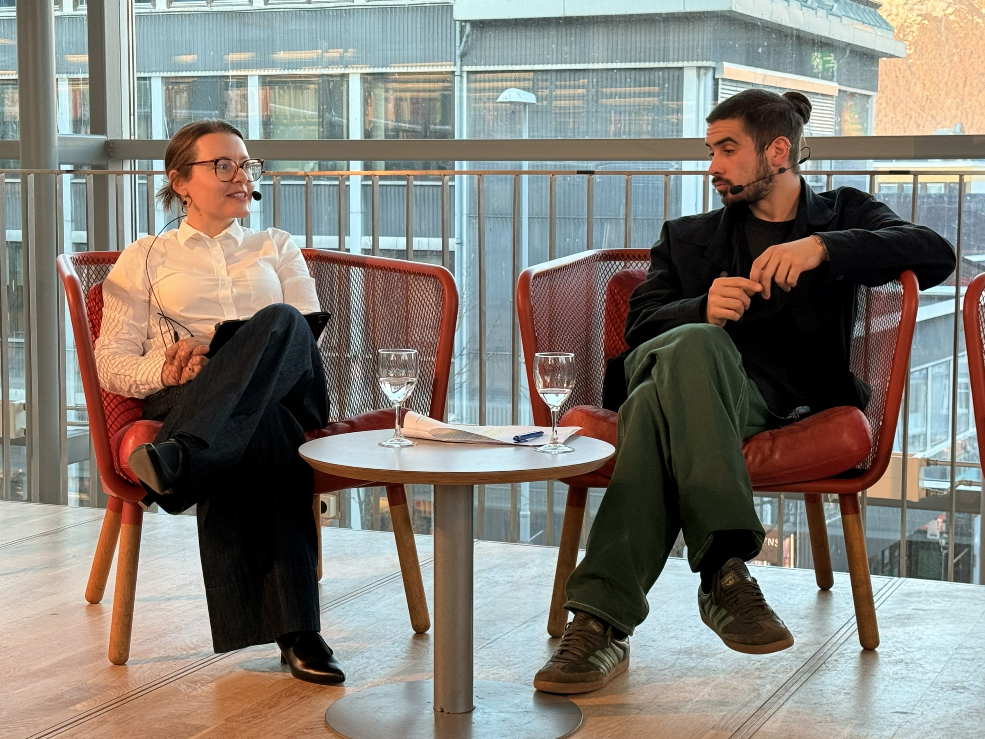 woman and man in red chair, windows in the back