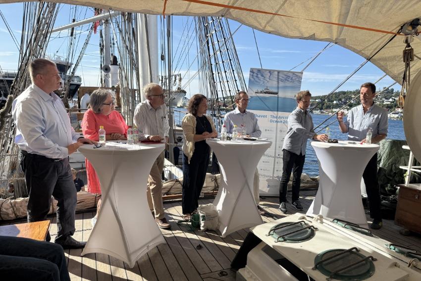 Folk i et panel p&aring; en seilskute